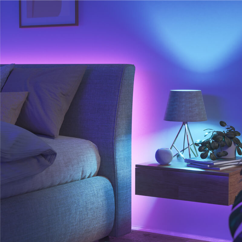Nanoleaf Essentials Thread enabled color changing smart light bulb mounted to a fixture in a bedroom. Similar to Wyze. HomeKit, Google Assistant, Amazon Alexa, IFTTT.